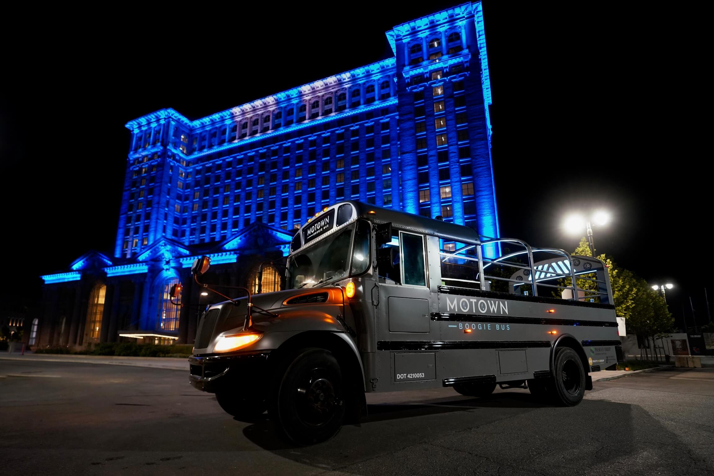 Motown Boogie Bus parked in front of Detroit skyline