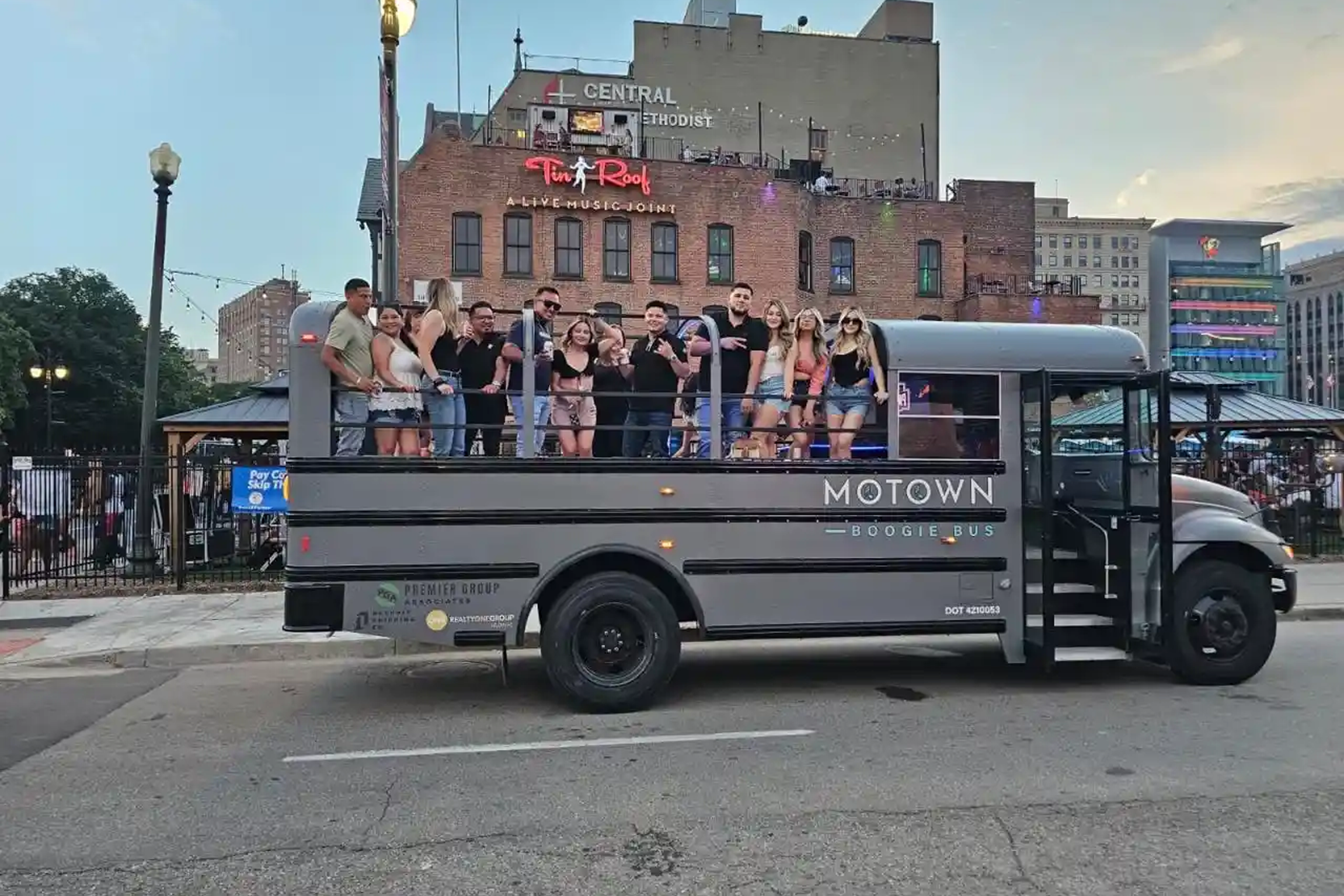Friends celebrating on a party bus in Detroit