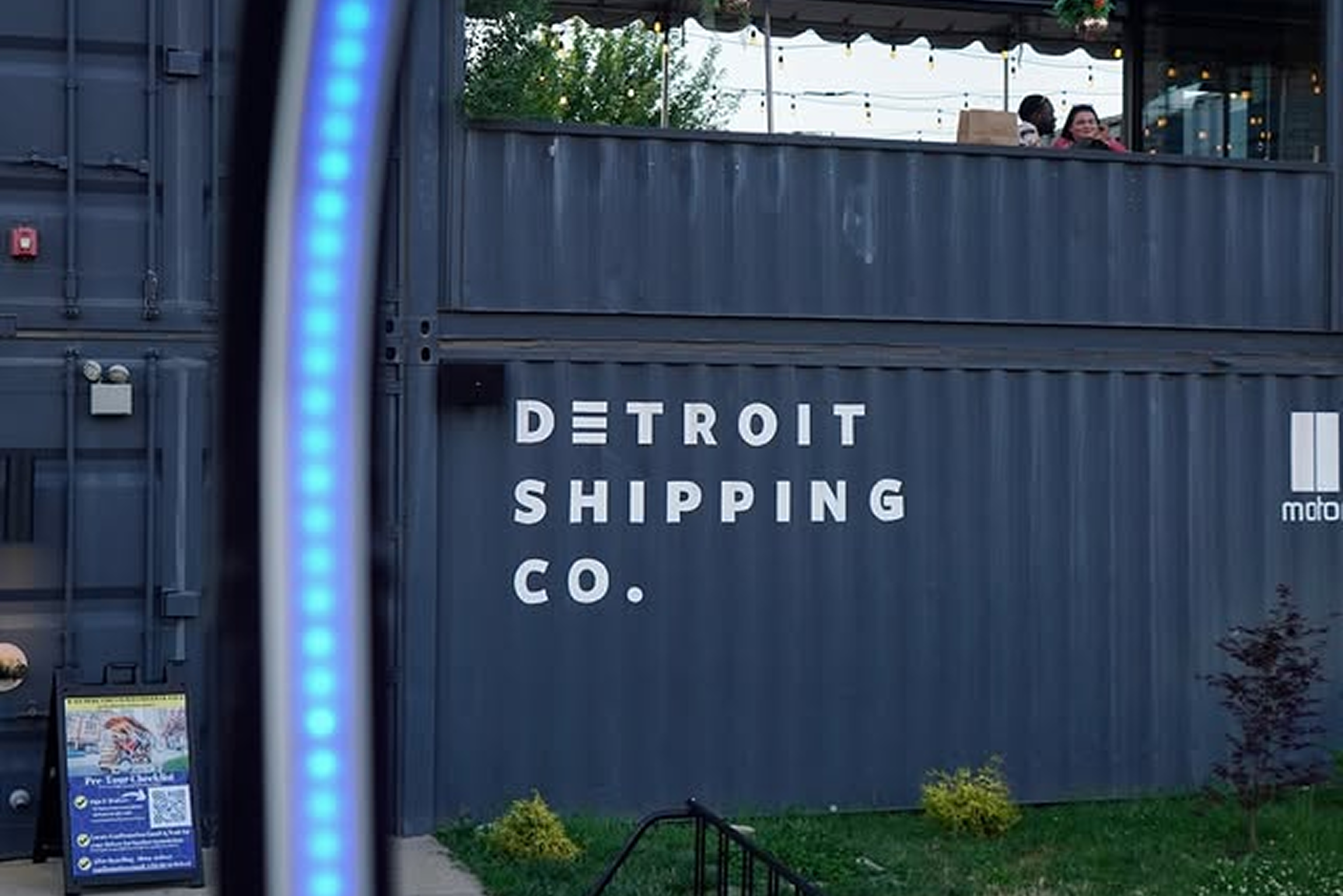 Motown Boogie Bus parked in front of Detroit skyline