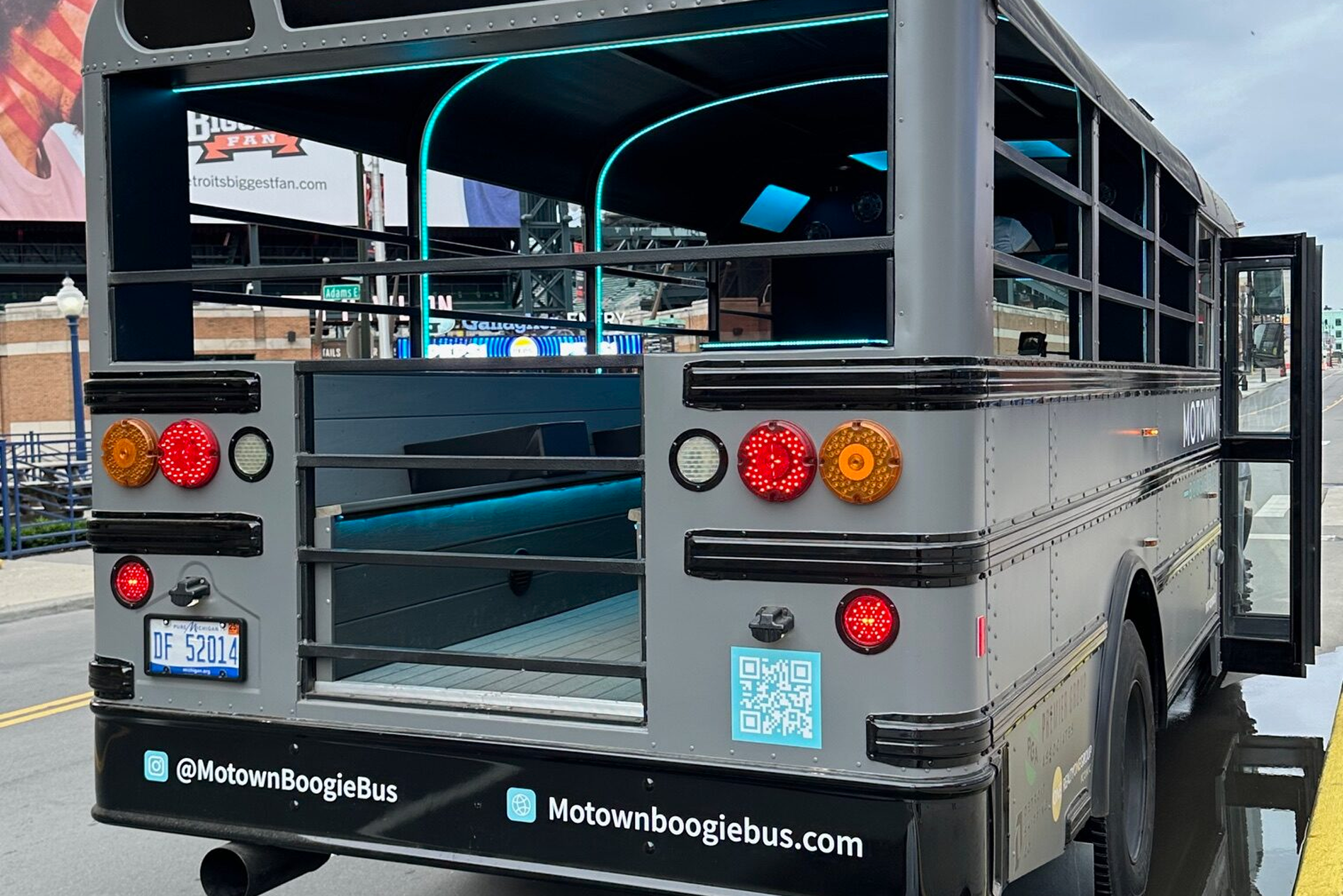 Motown Boogie Bus parked in front of Detroit skyline