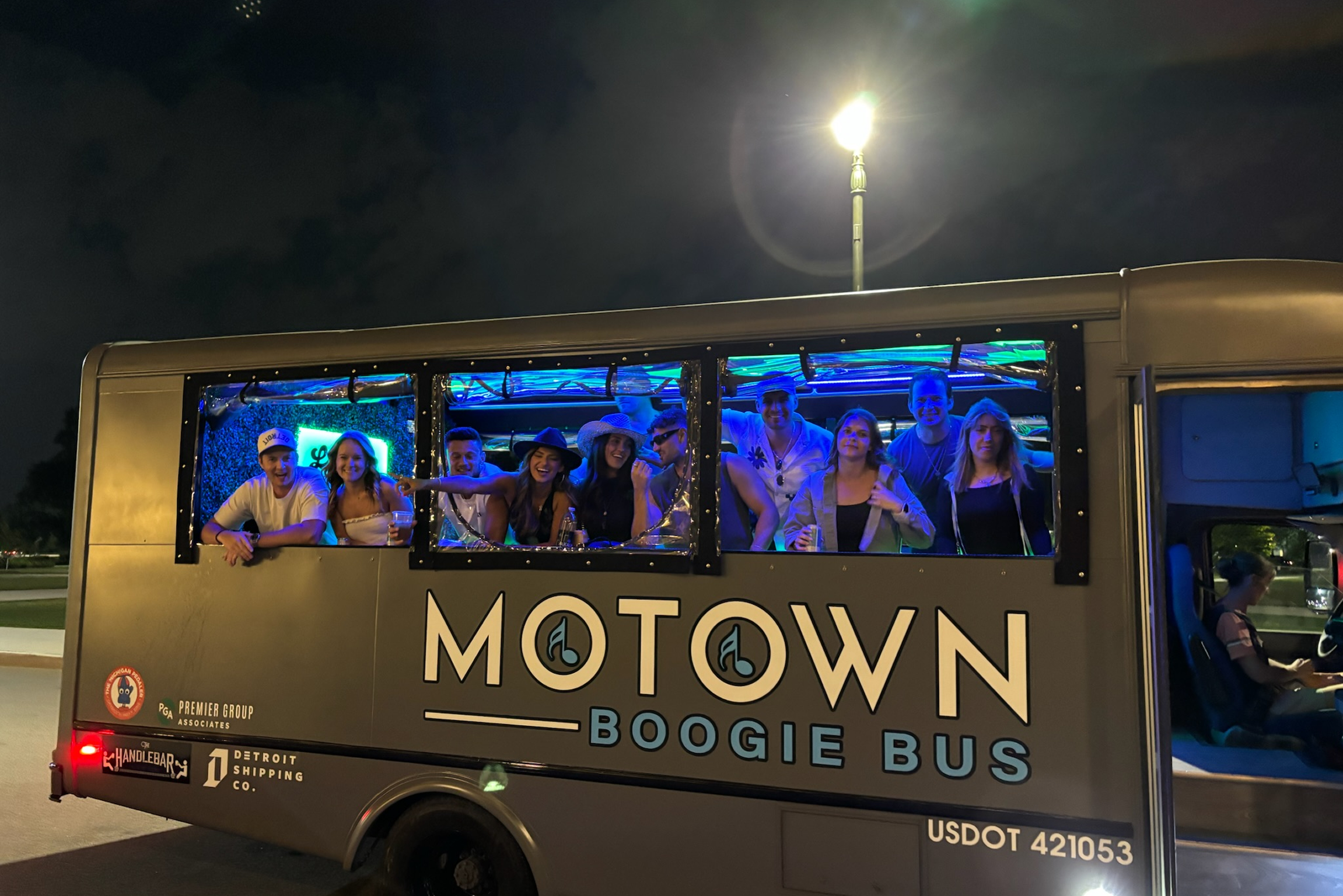 Friends celebrating on a party bus in Detroit