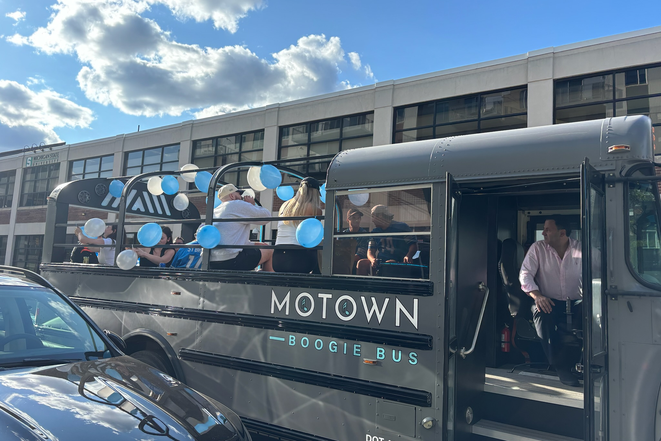 Friends celebrating on a party bus in Detroit